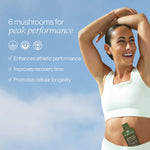 Longevity Mushrooms pouches displayed by a smiling woman promoting peak performance and cellular longevity.
