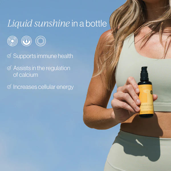 Vitamin D3 + K2 + CoQ10 supplement bottle held by model outdoors with benefits outlined.
