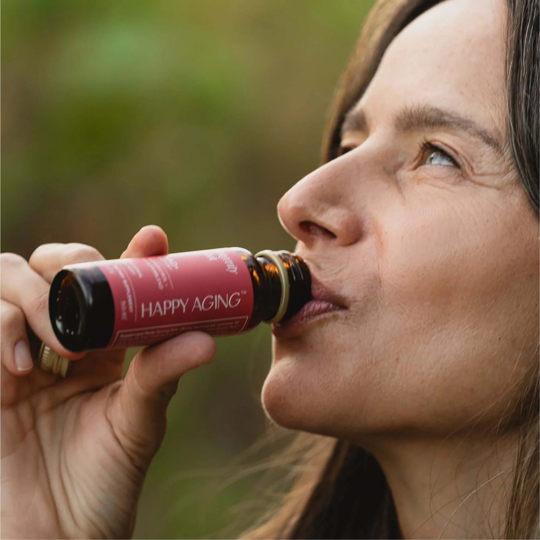 Woman enjoying NAD+ Longevity Shots for cellular repair and skin radiance.
