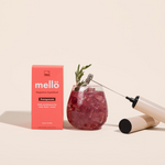 NED - Mellö Magnesium - Travel Sticks displayed with a pomegranate drink and garnished with rosemary.