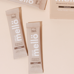 NED - Mellö Magnesium - Travel Sticks packets on a pale surface, highlighting the unflavored magnesium superblend.
