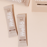 NED - Mellö Magnesium - Travel Sticks packets on a pale surface, highlighting the unflavored magnesium superblend.