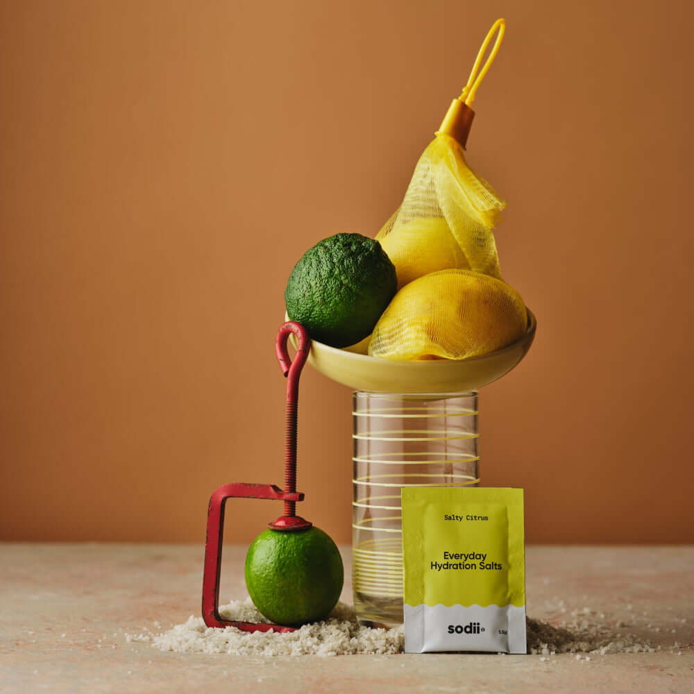 Sodii - Everyday Hydration Salts with fresh citrus fruits on display, showcasing a clean hydration solution.