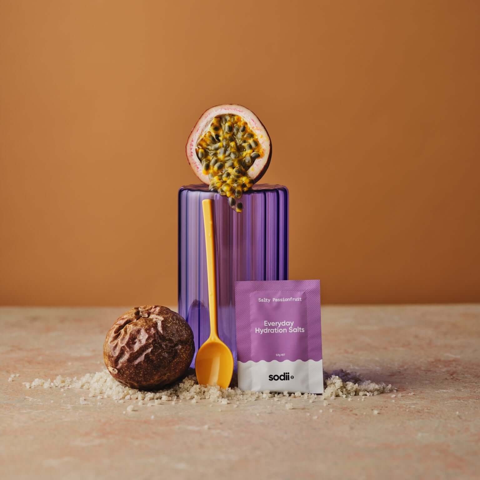 Sodii - Everyday Hydration Salts package with passion fruit and salt, showcasing hydration support in a vibrant setup.